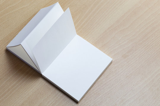 Blank white business cards on wooden background for branding identity and designers.