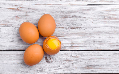 several eggs lie on a wooden table, cooking