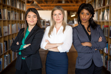 Diverse multiethnic group of business women make strong team powerful stare confident and successful 