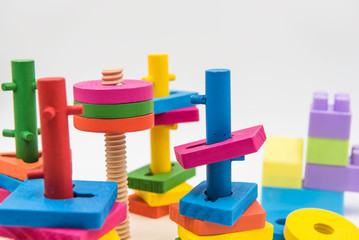 Children's toys are made of colorful wood on a white background.