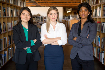 Young bright diverse legal attorney group stand powerful with confident success expression