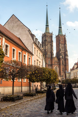 Obraz premium 23rd October 2016: Three nuns walk down the road towards Wroclaw Cathedral, Poland.