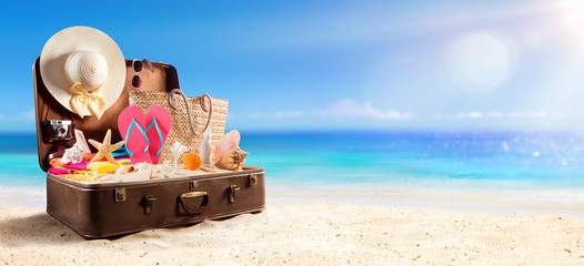 Beach Accessories In Suitcase On Beach - Travel Concept
