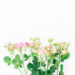 Flowers background. Bouquet made of pink roses, leaves and buds on white background. Flat lay, top view.