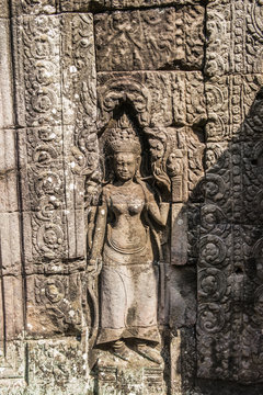 Khmer devata guarding the temple shown in stone in Banteay Kdei temple in Angkor, Siem Reap, Cambodia.