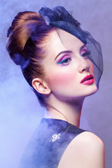 Fototapeta premium Beautiful girl with hairdo and bright make-up