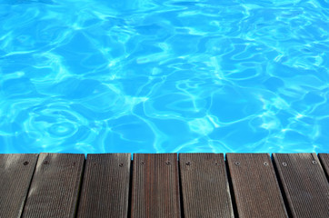 Deck and clear turquoise water background