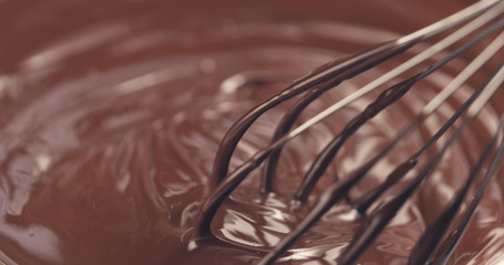 mixing melted premium dark chocolate with a whisk toned, 4k photo