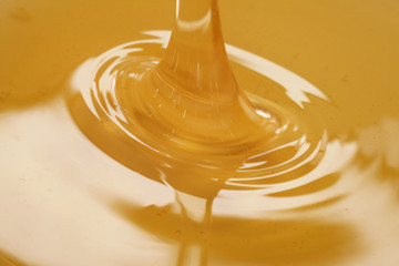 closeup of pouring organic honey, amber golden color