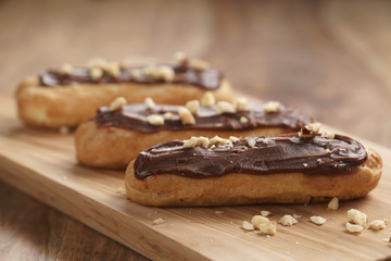 traditional french eclairs with chocolate and hazelnuts, shallow focus