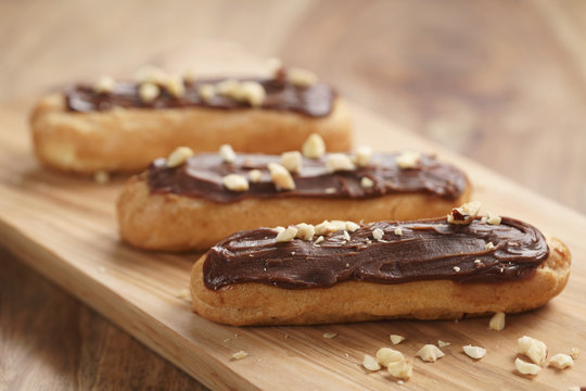 traditional french eclairs with chocolate and hazelnuts, shallow focus