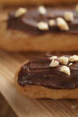 traditional french eclairs with chocolate and hazelnuts, shallow focus