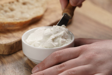 taking ricotta cheese to spread on bread, shallow focus
