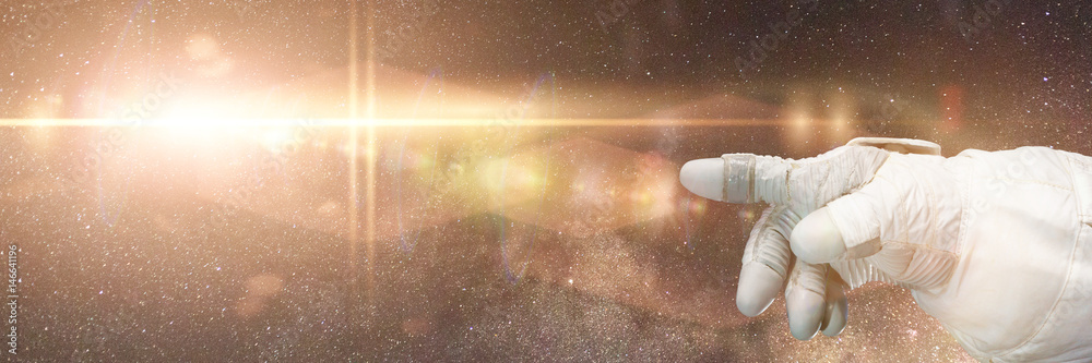 Canvas Prints astronaut pointing to a bright star in front of the milky way galaxy