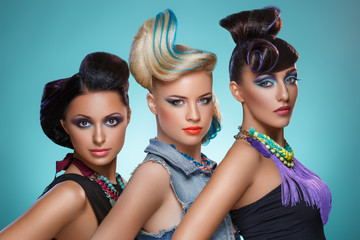 Beautiful girls with fancy hairstyles and vivid makeup