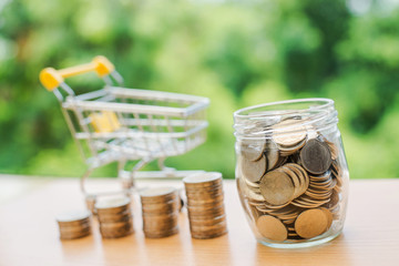 Shopping cart Money in glass and Money Stack, Business success growing concept.