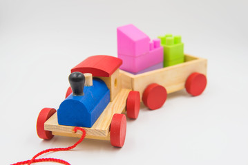 Toy train made of colorful wood on a white background.