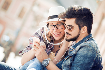 Couple listening to music on headphones