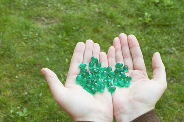 green tablets on palm