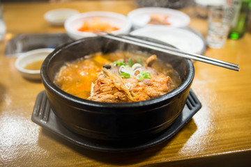A bowl of soupin the korean restaurant.