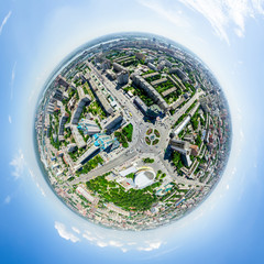 Aerial city view with crossroads and roads, houses, buildings, parks and parking lots, bridges. Urban landscape. Copter shot. Panoramic image.