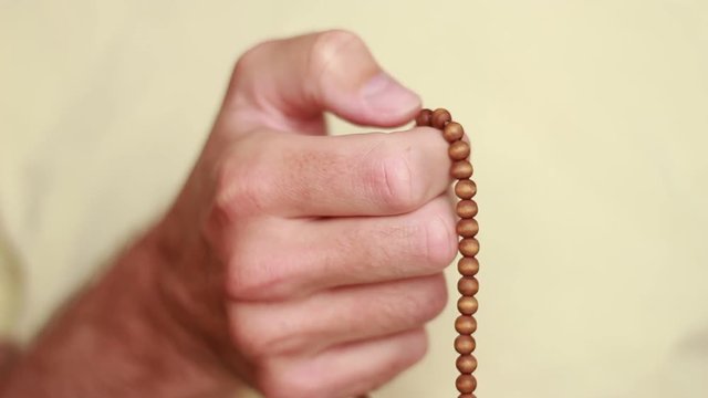 Male hand with beads