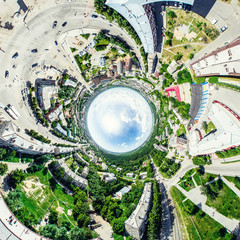 Aerial city view with crossroads and roads, houses, buildings, parks and parking lots, bridges. Helicopter drone shot. Wide Panoramic image.