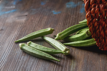 Lady Fingers or Okra over wooden table background.