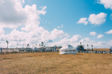Fototapeta na wymiar a yurt in mongolia grassland with blue sky,horizontal
