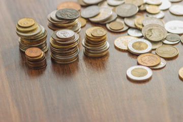 Different gold and silver collector's coins on the wooden table