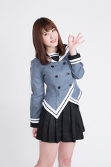 若い女性が制服を着ています。AKBのようなコスチュームです。この画像は、広告宣伝に使えます。画像の背景は、白です。