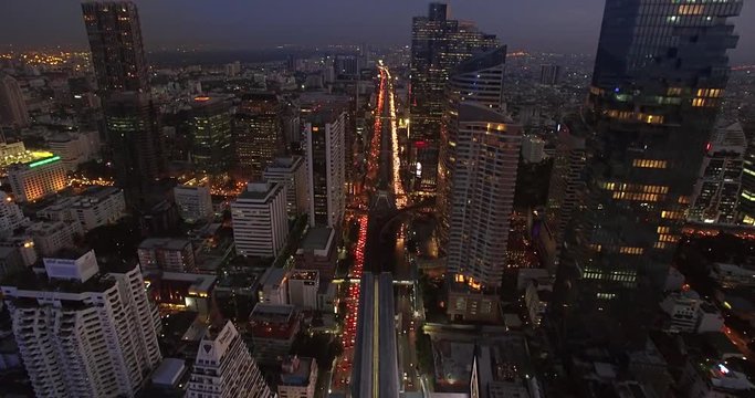 Rush Hour Traffic at Dusk in Sathorn, Bangkok, Thailand, Ascending Drone Shot
