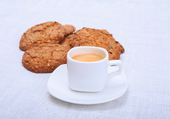 Crispy fresh croissants and cup of coffee espresso on a white background, morning breakfast, selective focus