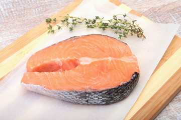 fresh raw salmon with spices on wooden cutting board. ready for cookin