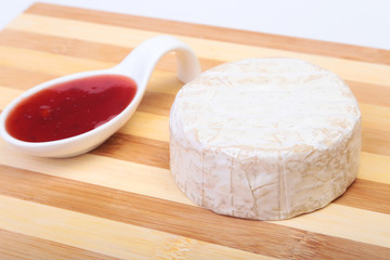 Cheese with white mold. Camembert or brie type with Cranberry sauce.. Healthy breakfast.