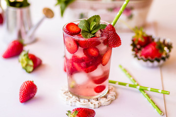 Homemade strawberry lemonade with mint on a white background