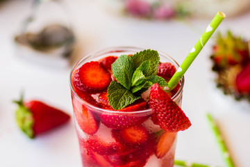 Homemade strawberry lemonade with mint on a white background