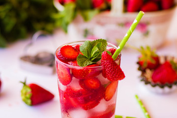 Homemade strawberry lemonade with mint on a white background