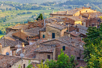 Obraz premium Tiled roofs below the medieval walls of Montepulciano in Tuscany, Italy