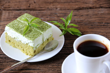 Green tea cake and hot coffee on the table