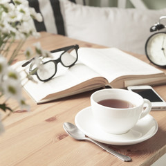 Composition with tea cup and book.