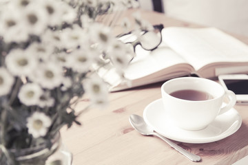 Obraz na płótnie Canvas Composition with tea cup and book.