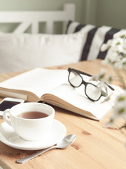 Composition with tea cup and book.