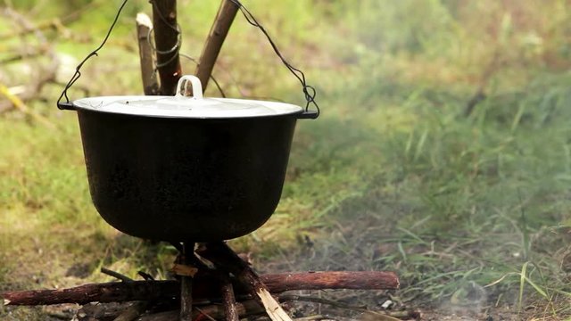 Kettle boiling over the bonfire in the camp