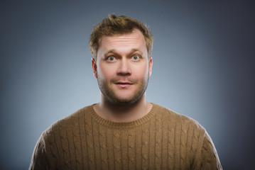 Close up face of discouraged man isolated grey background