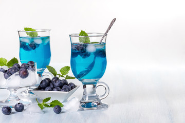 Alcoholic cocktail with blueberries and mint. Space for text