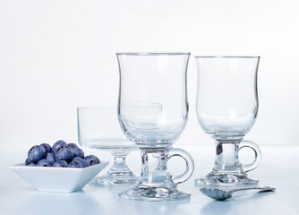 Composition of empty glasses and blueberries