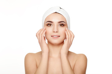 Beautiful young woman touching her face on a white background