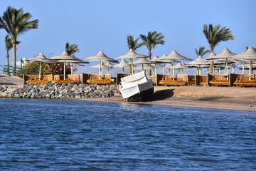 Idyllic blue sea shore with white motor boat