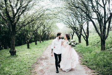Fototapeta premium Loves and very happy groom and bride in the park